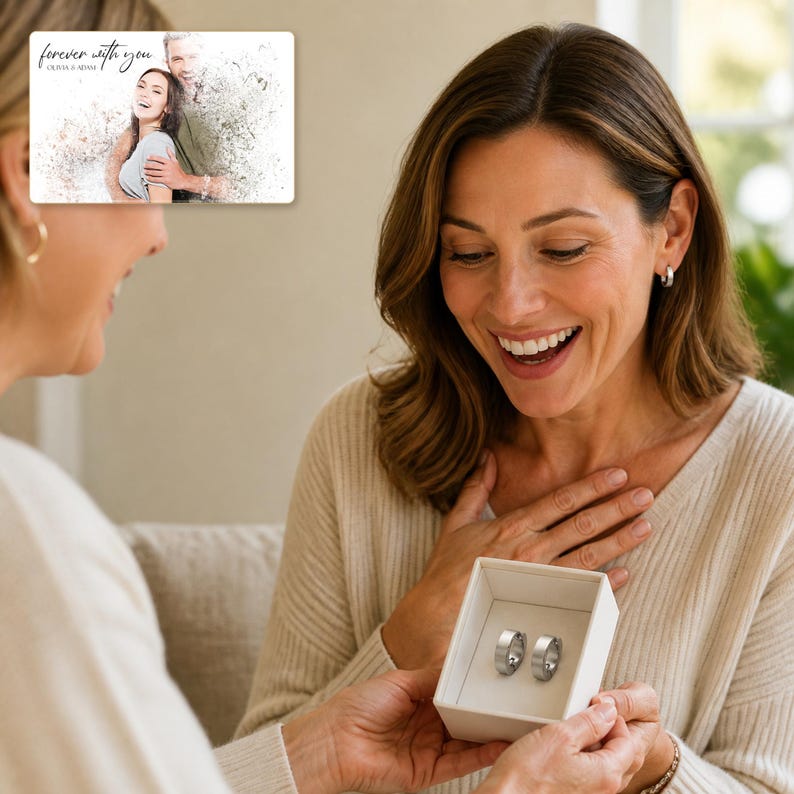 May include: A rectangular card featuring a stylized photo of a couple with the text "forever with you" and "OLIVIA & ADAM" above a small white gift box containing two silver-toned metal rings with a smooth, polished finish and a simple band design.