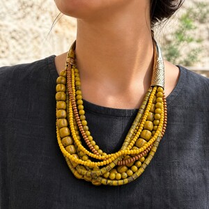 Three-piece handmade necklace set featuring rose gold and gold beaded necklace, rose gold and bronze beaded necklace and rose gold and beige beaded necklace, displayed together to show the coordinated colors and beadwork