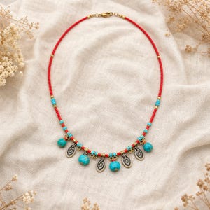 Turquoise Red Beaded Charm Necklace presented in an open jewelry gift box on natural linen