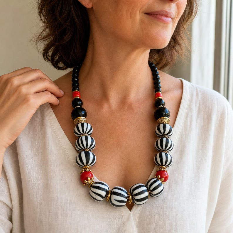 Brown and Silver Statement Beaded Necklace displayed on a jewelry bust, showing the necklace shape and artisan bead details