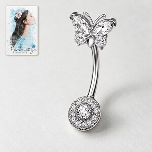 Silver-tone butterfly navel bar with clear marquise upper wings, round lower wings and a pavé disc on pale porcelain. A personalized digital greeting card is shown alongside.