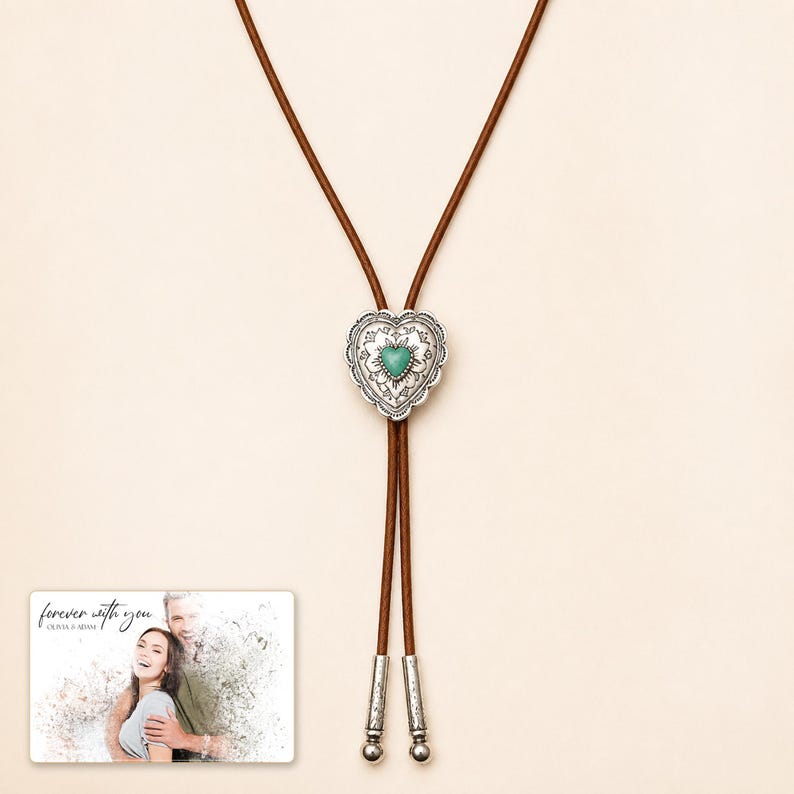 Brown cord bolo necklace with a silver-tone heart slide and turquoise-color center, display view. A personalized greeting-card example appears in the corner.