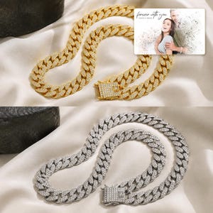 May include: A gold-tone and a silver-tone cuban link chain necklace, both fully encrusted with clear crystals and featuring a rectangular box clasp. A rectangular card is included with the text "forever with you" and "OLIVIA & ADAM".