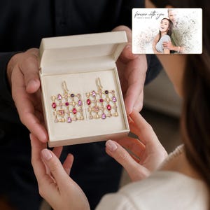 Prism Garden Sparkle Drops shown during a believable gift-giving moment between adults with the exact jewelry visible.