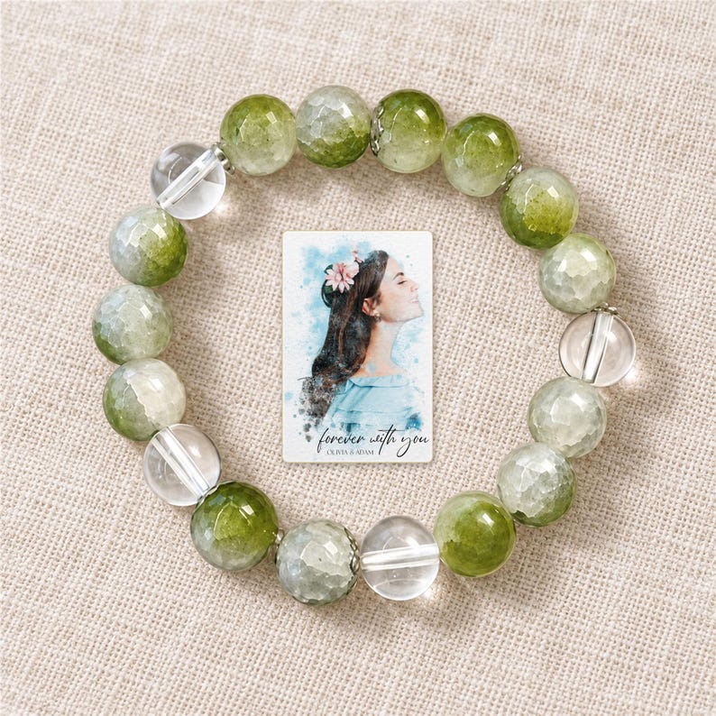 Forest Dew Bead Bracelet arranged on soft ivory linen in a refined neutral flat lay. A personalized digital greeting card is shown alongside.