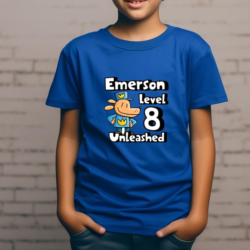 May include: A blue t-shirt with a cartoon dog wearing a hat and the text "Emerson Level 8 Unleashed".