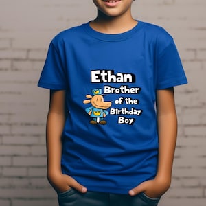 May include: A blue t-shirt with a cartoon dog wearing a hat and the text "Ethan Brother of the Birthday Boy".