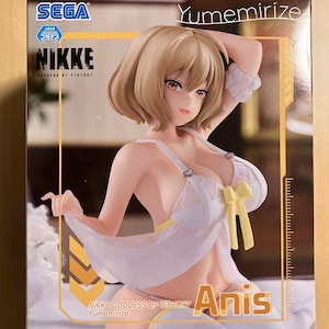 May include: A figure of Anis from the game Nikke: Goddess of Victory. The figure has blonde hair and is wearing a white outfit with yellow accents. The figure is part of the Yumemirize collection.