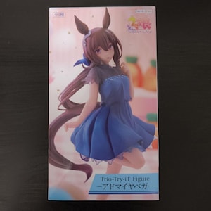 May include: A boxed Trio-Try-iT Figure of a character with brown hair, bunny ears, and a blue dress. The figure is in a dynamic pose against a colorful background. The box has Japanese text.