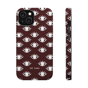 May include: A dark brown smartphone case featuring a repeating pattern of white stylised eyes with eyelashes. The text SEE SWAG is printed in white near the bottom centre. The case includes a camera cutout and side button covers for a phone.