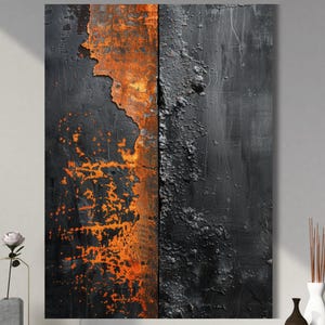 May include: Abstract wall art featuring a split design with a textured, weathered appearance. The left side displays vibrant orange rust against a black background, while the right side has a dark, textured surface. The artwork is displayed on a dark wooden surface.