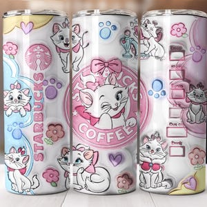 May include: A set of three white stainless steel tumblers featuring a design with a pink Starbucks logo and cartoon images of a white cat with a pink bow. The tumblers have a white background with pink and blue accents.