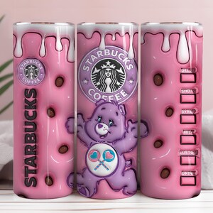 May include: A pink Starbucks tumbler featuring a purple Care Bear with a heart-shaped lollipop. The design includes the Starbucks logo, chocolate-colored accents, and a white dripped frosting effect. The tumbler also has a drink measurement guide.