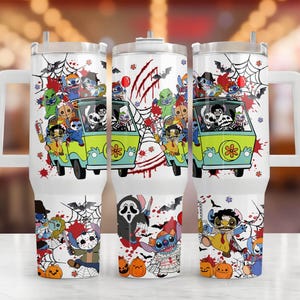 May include: White tumbler with a Halloween design. The design features a green van with cartoon characters, spiderwebs, bats, and pumpkins. The tumbler has a handle and a straw.