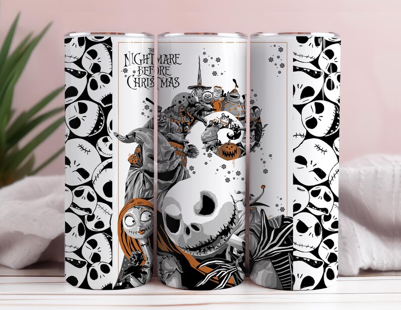 May include: A white tumbler featuring a design from "The Nightmare Before Christmas." The design includes Jack Skellington, Sally, and other characters in grayscale with orange accents. The tumbler has a repeating skull pattern.
