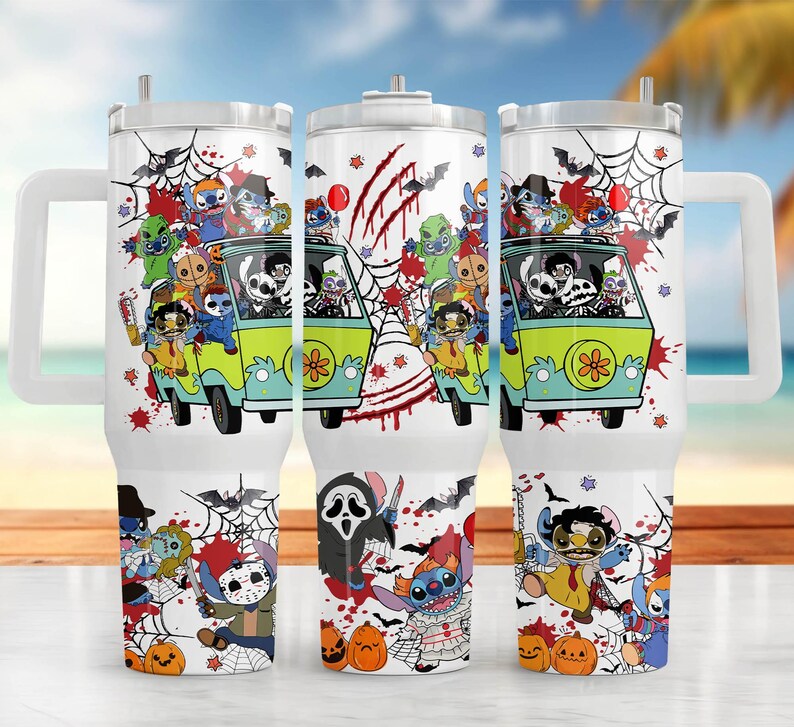 May include: White tumbler with a Halloween-themed design. The design features a green van with cartoon characters, spiderwebs, bats, and pumpkins. The tumbler has a handle and a straw.