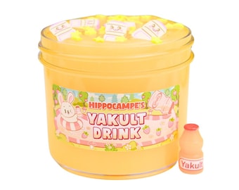 May include: A yellow slime jar with a label that says "Hippocampe's Yakult Drink". The slime is topped with white marshmallows and yellow stars. A small plastic Yakult bottle is next to the jar.