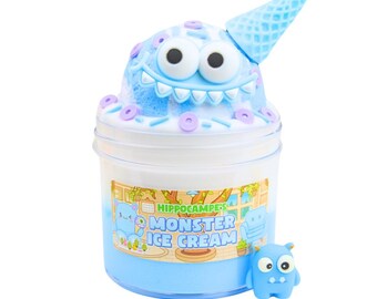 May include: Blue and white monster ice cream slime in a clear jar with a blue monster face on top. The jar has a label that says "Hippocampe's Monster Ice Cream". There is a small blue monster figurine next to the jar.