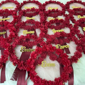 There are bridesmaid tambourines. bridesmaid text made by gold color arclic letters. frame made by laser cut flowers and some satin tails