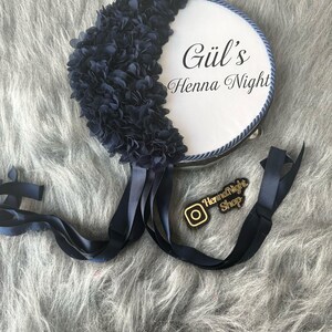 A blue bride tambourines.  frame made by laser cut flowers and some satin tails