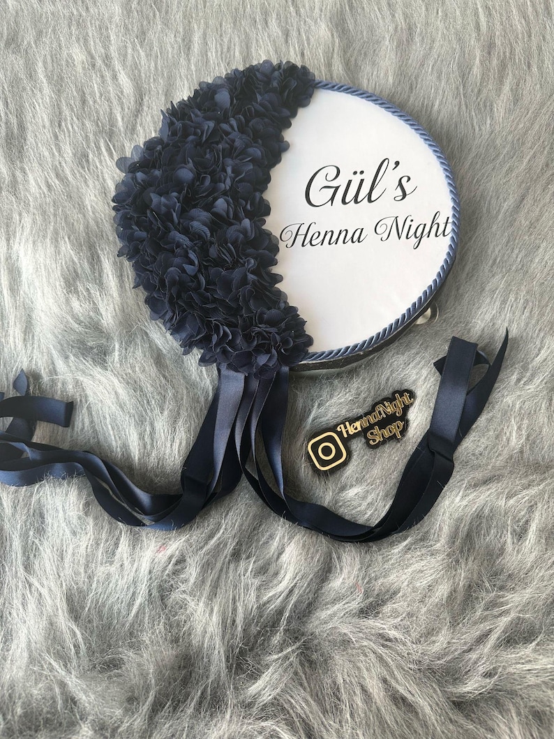 A blue bride tambourines.  frame made by laser cut flowers and some satin tails