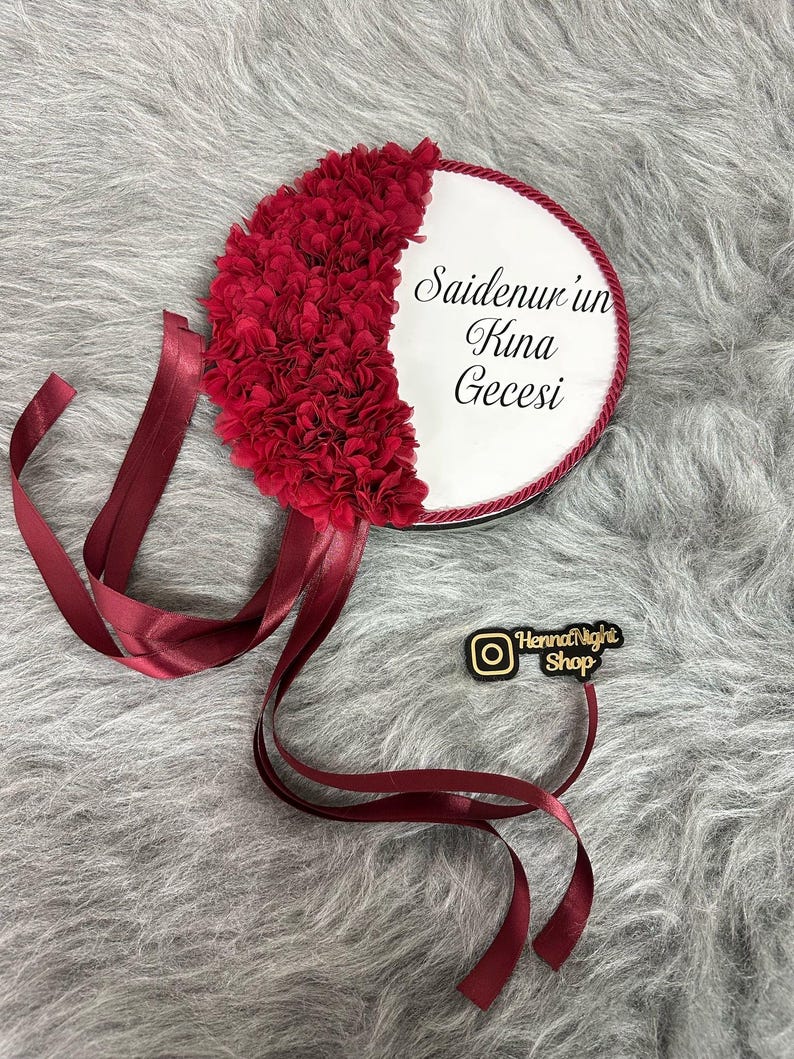 A red bride tambourines.  frame made by laser cut flowers and some satin tails