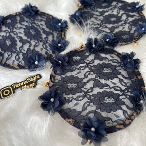 There are blue bridesmaid tambourines. frame made by laser cut flowers and some satin tails