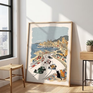 May include: A framed art print featuring a stylized illustration of a Formula One race along a coastal city harbor. The scene includes multiple racing cars on a track, a crowd of spectators, and two cats in the foreground watching the race.