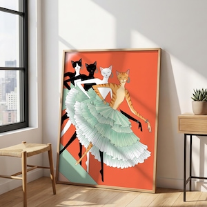 May include: A framed art print featuring four anthropomorphic cats wearing hoop earrings and layered, ruffled, light green ballet skirts. The cats are depicted in various colors including orange tabby, white, and black, set against a vibrant orange background.