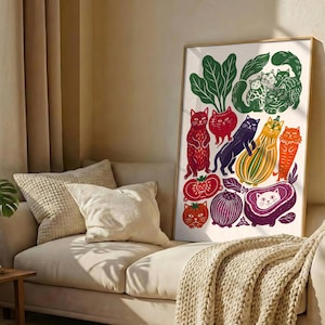 May include: A vertical rectangular framed print featuring a colorful illustration of various cats integrated with vegetables and fruits. The artwork displays cats in shades of red, orange, purple, and green, depicted alongside images of tomatoes, onions, and squash.