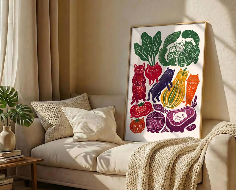 May include: A vertical rectangular framed print featuring a colorful illustration of various cats integrated with vegetables and fruits. The artwork displays cats in shades of red, orange, purple, and green, depicted alongside images of tomatoes, onions, and squash.