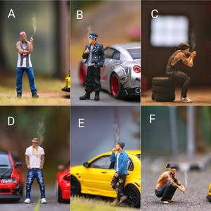 May include: Six miniature figures of people smoking cigarettes, each posed in a different way. The figures are all wearing different clothing and accessories. Some of the figures are standing next to miniature cars.