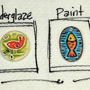 May include: Four ceramic tiles showcasing different finishes: glaze, underglaze, paint, and bisque. The glaze tile features a blue and white geometric pattern, the underglaze tile depicts a red bird on a green branch, the paint tile has a blue and orange fish, and the bisque tile is white with a floral design.