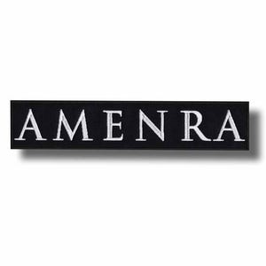 May include: Black rectangular patch with the word "AMEN RA" embroidered in white capital letters. The patch has a clean, minimalist design, suitable for various applications.