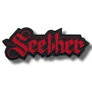 May include: Embroidered patch featuring the word "Seether" in a gothic font. The text is red, outlined in black, and set against a black background. The patch has a jagged edge, giving it a bold, edgy look.