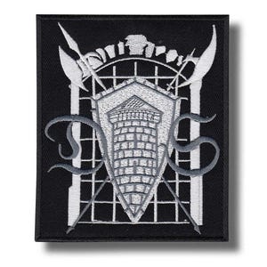 May include: Black embroidered patch featuring a white and gray heraldic design. The design includes a shield with a brick tower, crossed spears, and stylized letters. The patch has a rectangular shape.