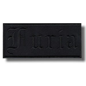 May include: A black rectangular patch featuring the name "Furia" in a gothic font. The patch is made of a textured fabric and has a simple, minimalist design. It is likely intended for application on clothing or accessories.