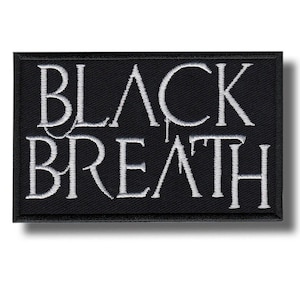 May include: A rectangular black patch with the words "BLACK BREATH" embroidered in white. The text is in a stylized font, with the letters slightly dripping. The patch has a black border.