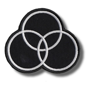 May include: Black patch featuring three interlocking circles with white outlines. The circles overlap, creating a unique design. The patch has a black background and a white border, creating a striking contrast. This patch is suitable for jackets, bags, or other fabric items.