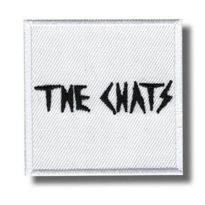 May include: A square, white patch with the text "THE CHATS" in black, stylized lettering. The word "CHATS" has lightning bolt accents. The patch has a white border and a textured surface.