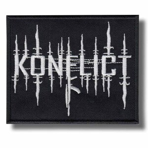 May include: Black rectangular patch with the word "KONFLICT" embroidered in white, stylized with vertical lines and a dripping effect. The patch is likely for clothing or accessories.