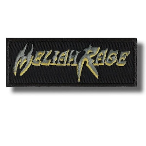 May include: A rectangular black patch embroidered with the words "Beliah Rage" in a stylized font. The text is primarily gray with yellow accents, creating a bold contrast against the dark background. The patch is likely for clothing or accessories.
