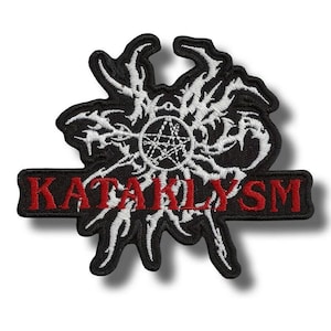 May include: Black and white embroidered patch with the word "KATAKLYSM" in red. The patch features a stylized design with a central pentagram and intricate white detailing, suitable for jackets or bags.