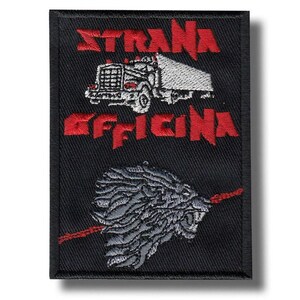 May include: Black rectangular patch with red text and embroidered images. The text reads "STRANA OFFICINA" above a truck and below a lion's head with a red line. The truck is white and the lion is gray.