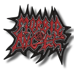 May include: A red and black embroidered patch with the word "MORBID ANGEL" in a stylized font. The patch has a jagged black border and white stitching. A pentagram is visible.