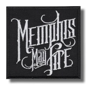 May include: Square black patch with white embroidered text that reads "Memphis May Fire" in a stylized font. The patch has a black border and a shadow effect.