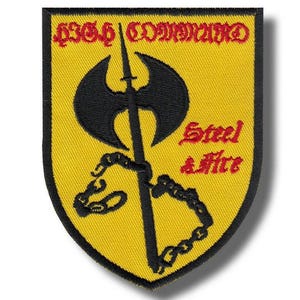 May include: A yellow patch with a black axe and spear design, with the words "436th COMMAND" in red at the top. The words "Steel & Fire" are also in red. A chain design is at the bottom.