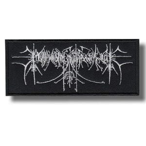 May include: A rectangular black patch with white embroidered text. The text is stylized and appears to be a band logo or design. The patch is likely for clothing or accessories.
