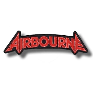 May include: A red and black embroidered patch featuring the word "AIRBOURNE" in bold, stylized letters. The text is framed by a black border with red arrow-shaped ends. The patch is designed for application on clothing or accessories.