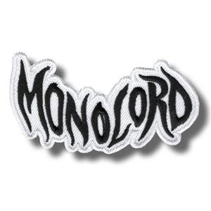 May include: Embroidered patch featuring the word "MONOLORD" in black, with a white border. The lettering is stylized. The patch has a shadow effect, giving a 3D look. Suitable for clothing or accessories.